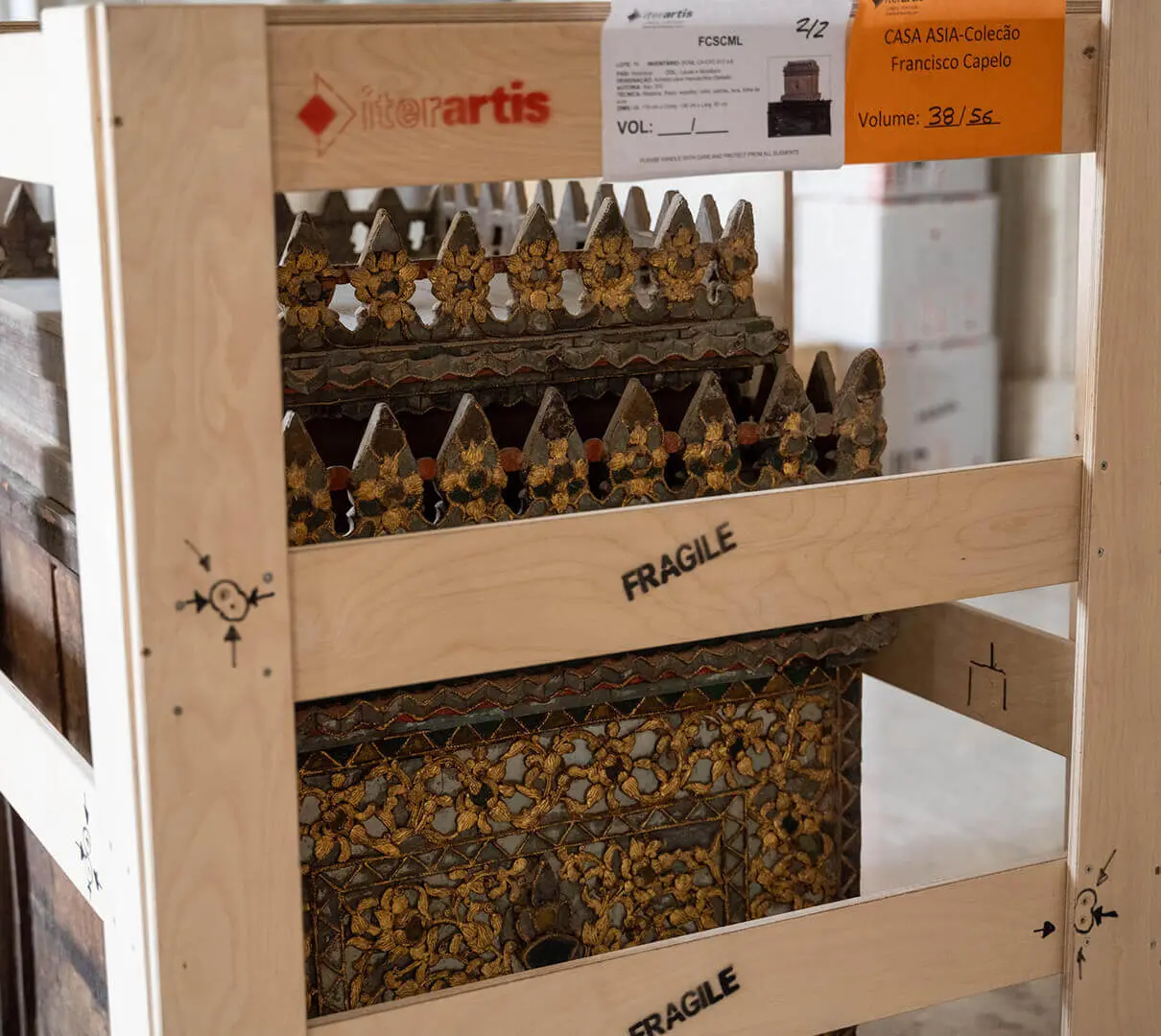 Wooden shipping crate marked “FRAGILE”, with the sutra cabinet inside