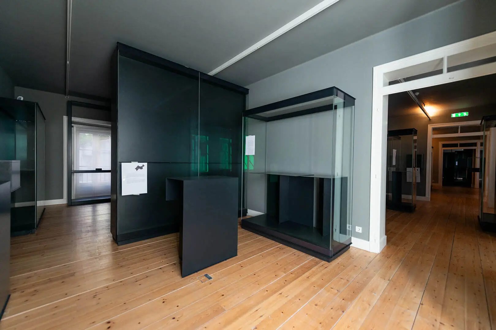 Empty exhibition room during installation, with display cases not yet filled